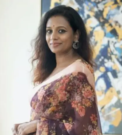 A headshot of Janaki Vedam, the Director of JanakiBhuvi Tech Labs Private Limited, smiling confidently. She is wearing a dark, professional outfit and her hair is neatly styled.